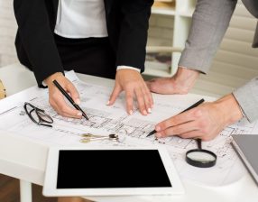 architects-studying-plan-with-mockup